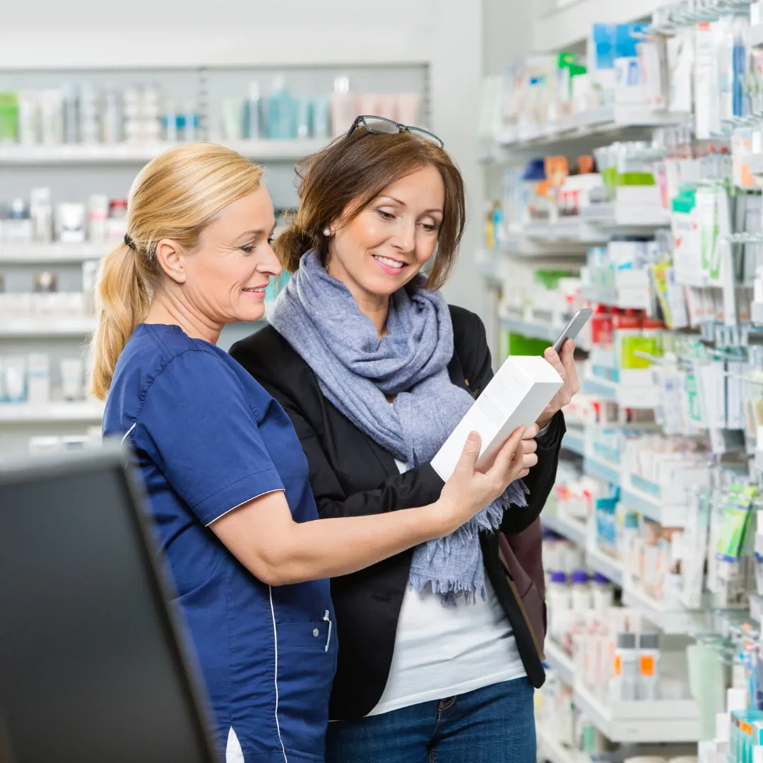 Pharmacy Technician Helping Woman