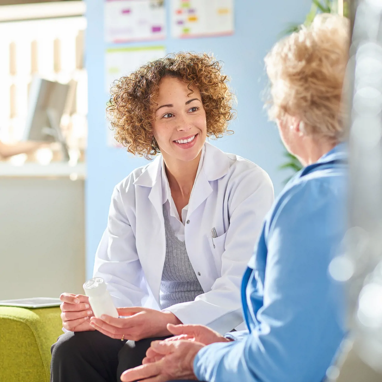 Pharmacy dispenser talking to patient