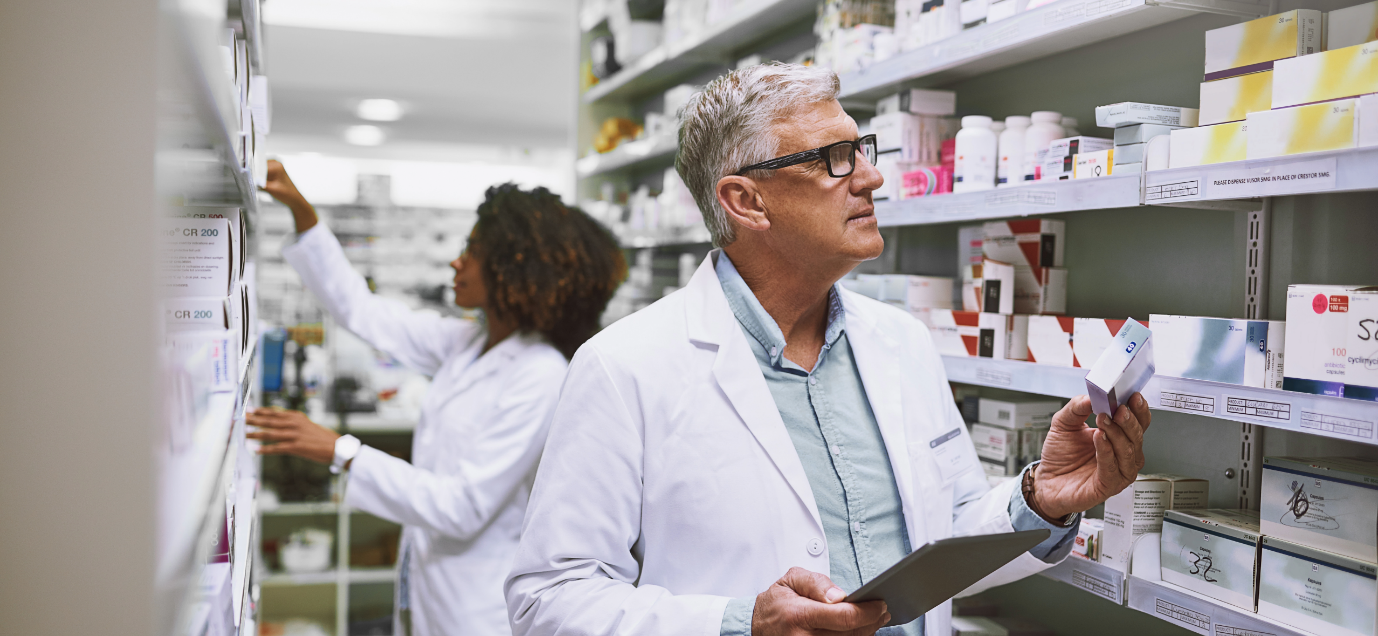 A person in a white coat holding a clipboardDescription automatically generated