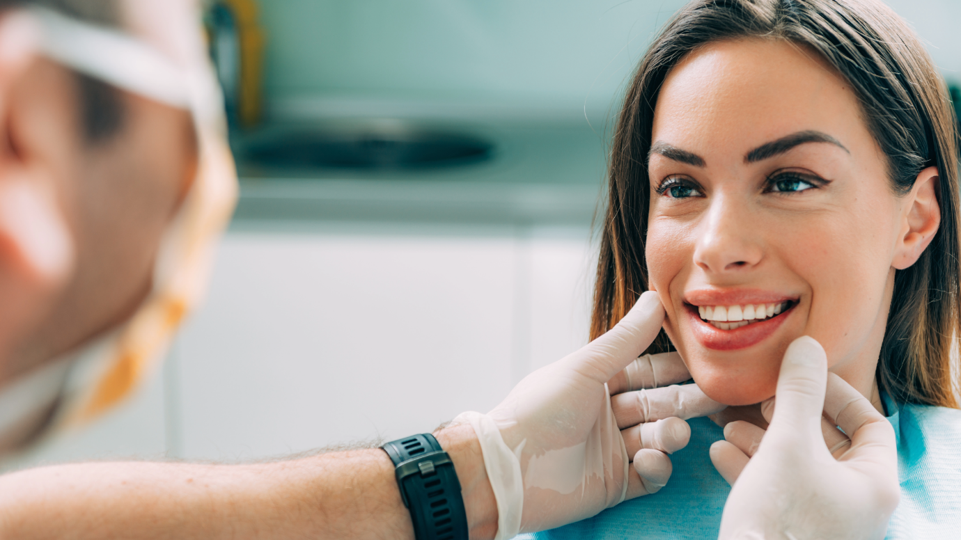 A person smiling with a doctor's handDescription automatically generated