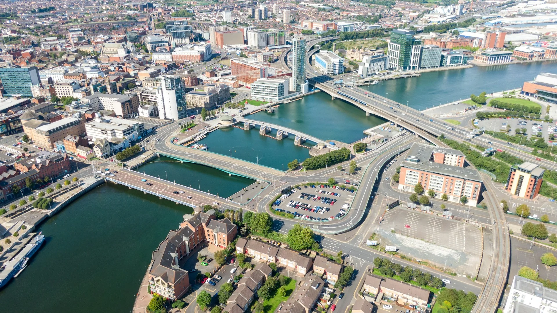 aerial-view-on-buildings-and-lagan-river-in-city-center-of-belfast-northern-ireland-drone-photo-high-angle-view-of-town-