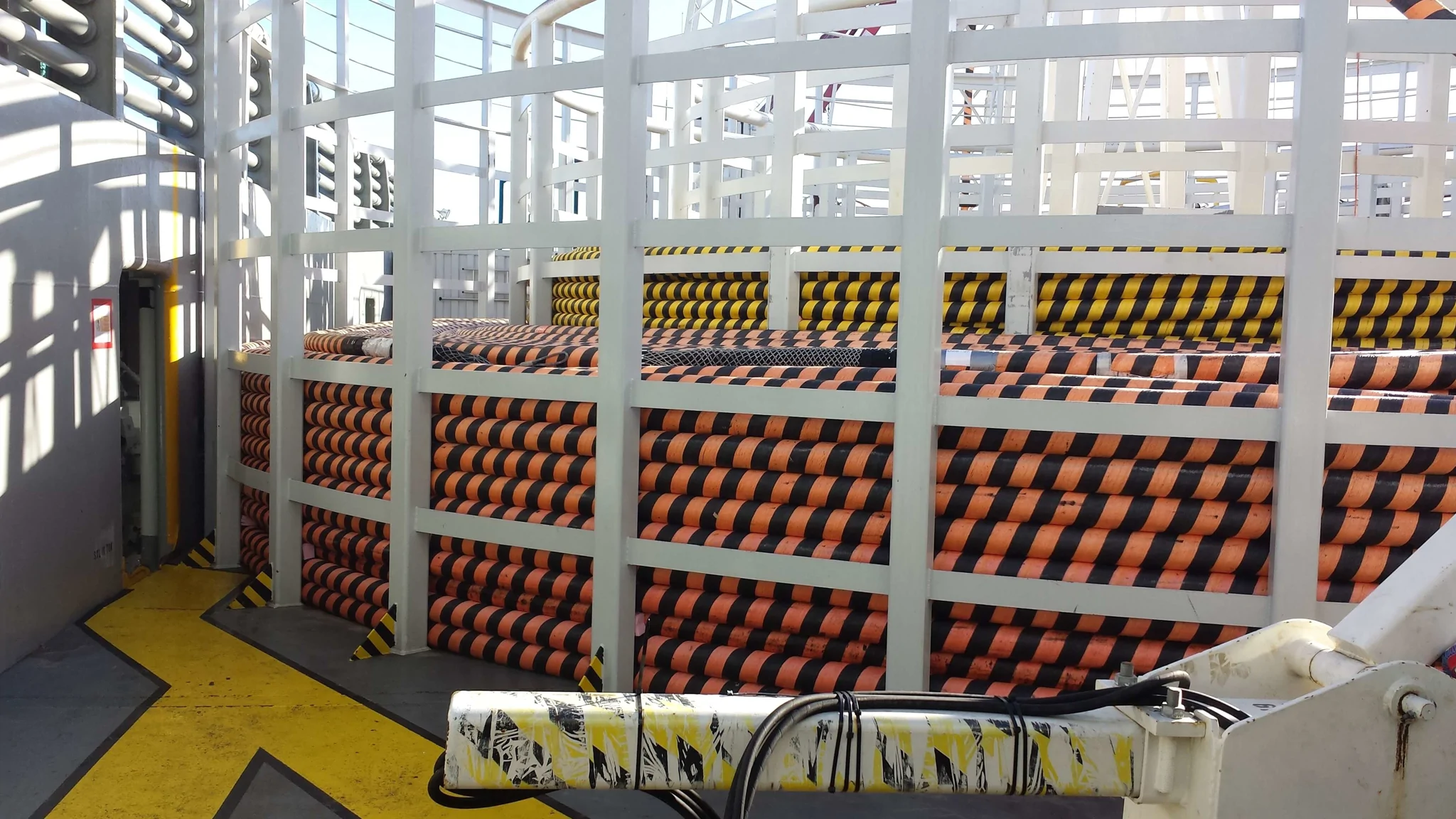 cables contained ready to be laid out into the ocean on vessel