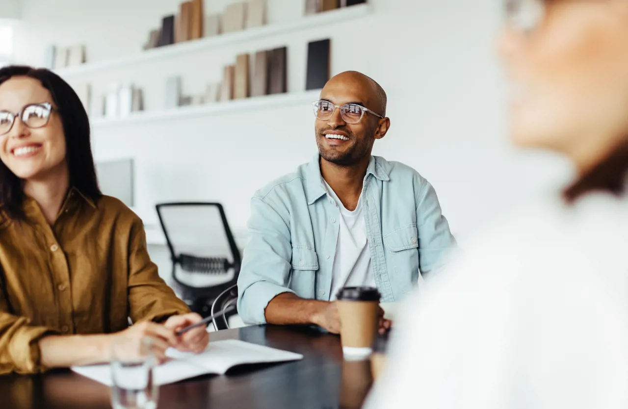 Creative business people listening to a group discussion in a meeting 