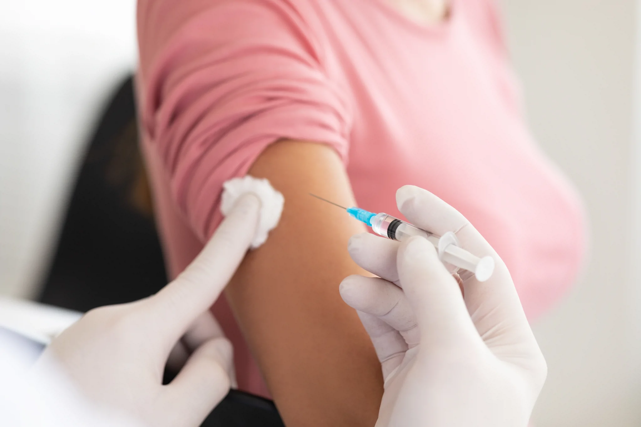 Doctor doing vaccination to young woman 