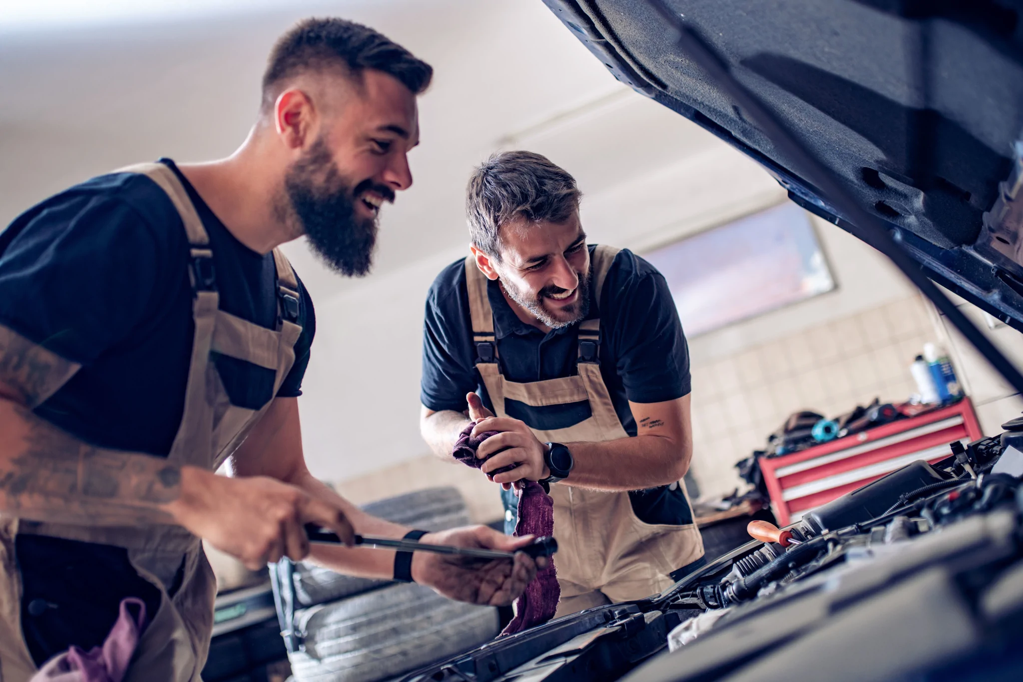Auto mechanics check the oil in the engine