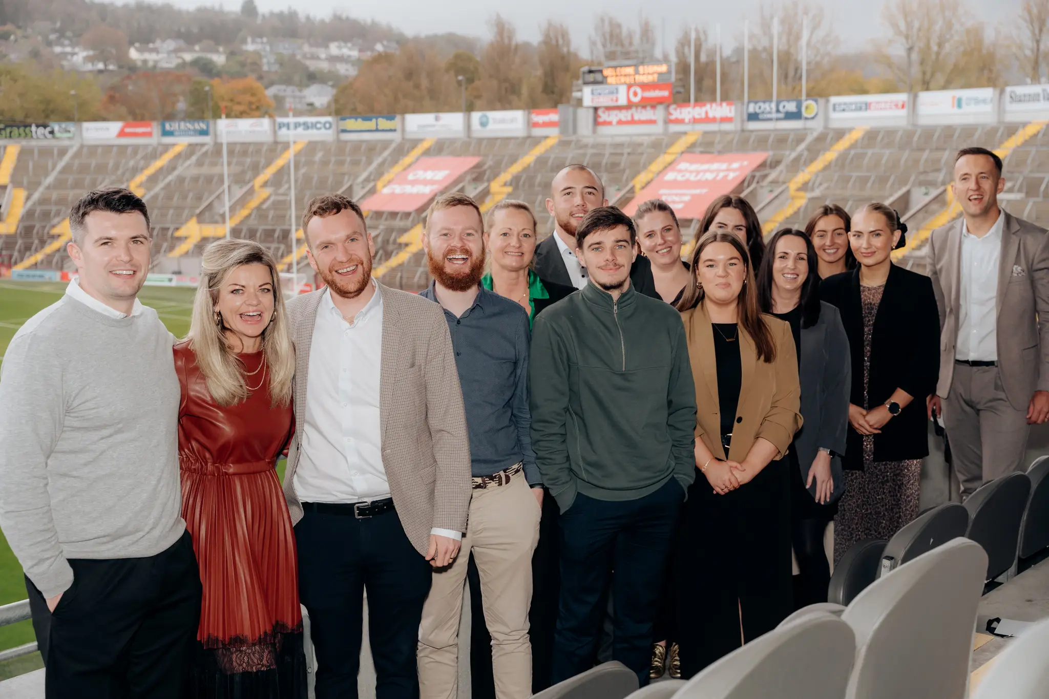 Part of the sigmar team in front of a sports stadium  