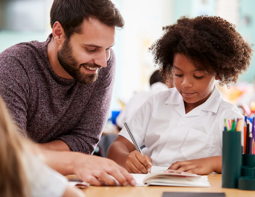 An adult helping a child with school work