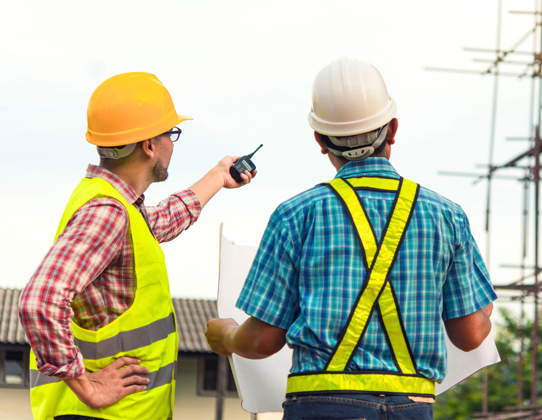 Two male construction workers looking at scaffolding