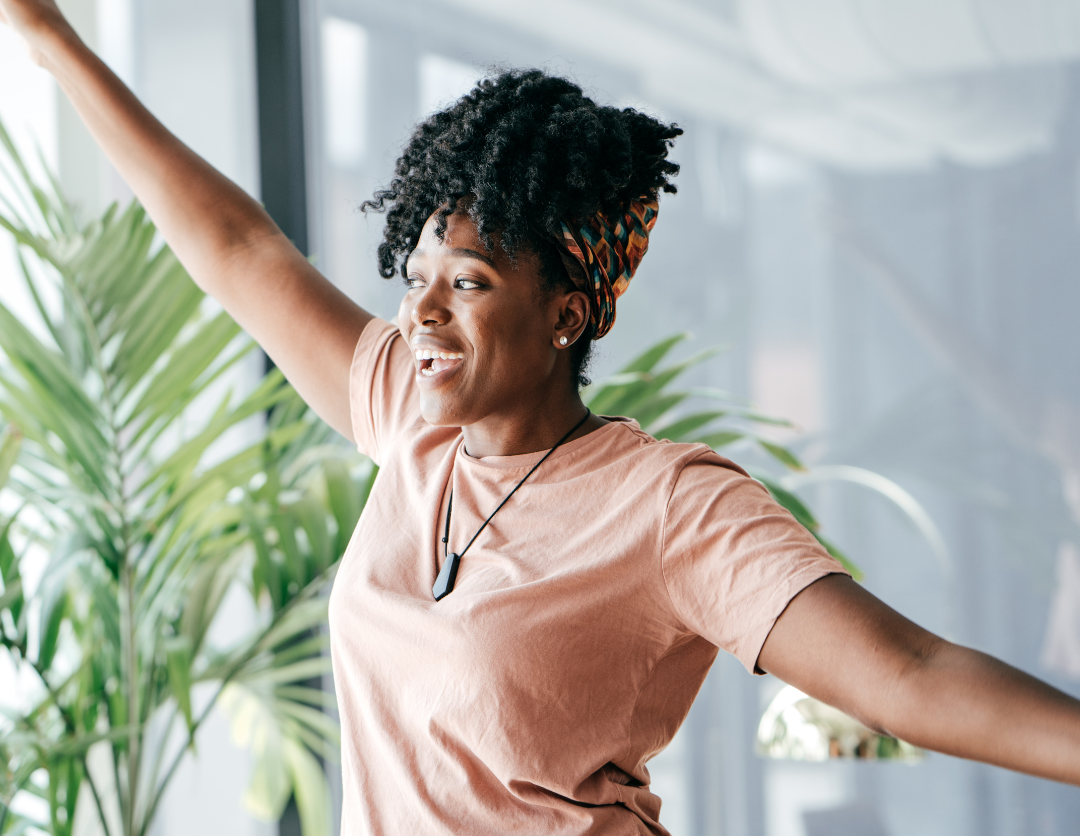 A lady stood with her arms in the air