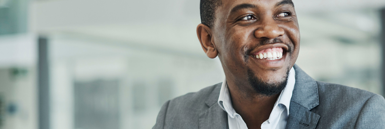 A man in a suit jacket smiling