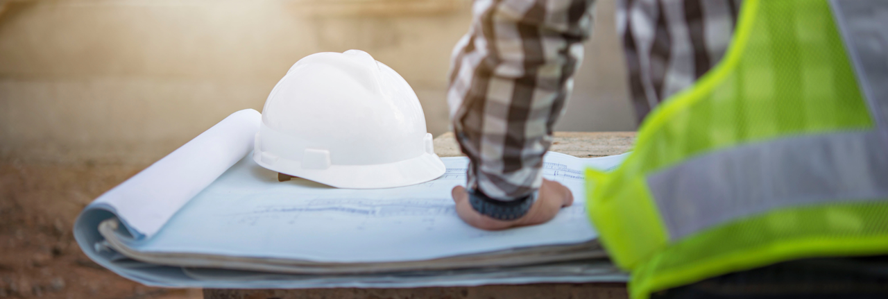 A construction workers hand leaning on instructions