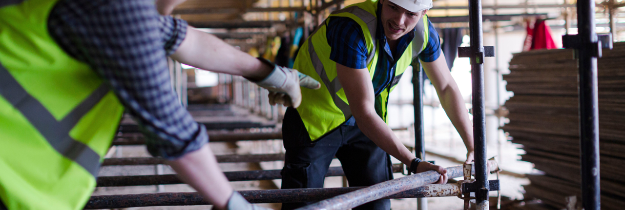 Two construction workers in high vis vests