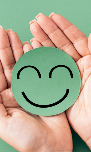 A smiley face being held in someone's hands