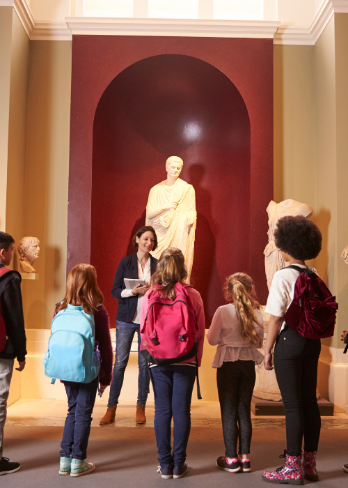 A group of students in a museum on a school trip