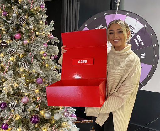 A female Spencer Clarke Group employee playing an office game of Deal or No Deal