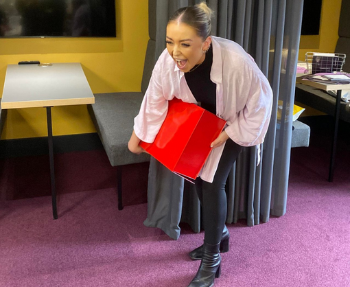 A female Spencer Clarke Group employee playing an office game of Deal or No Deal