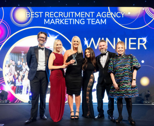 Employee, Debbie Holden, and colleagues on stage after winning Best Recruitment Marketing Team