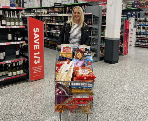 Employee, Debbie Holden, with a collection of food for a food bank