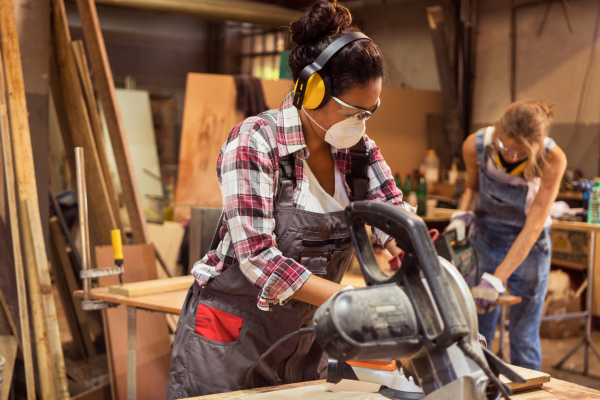 A Carpenter using a hand tool 