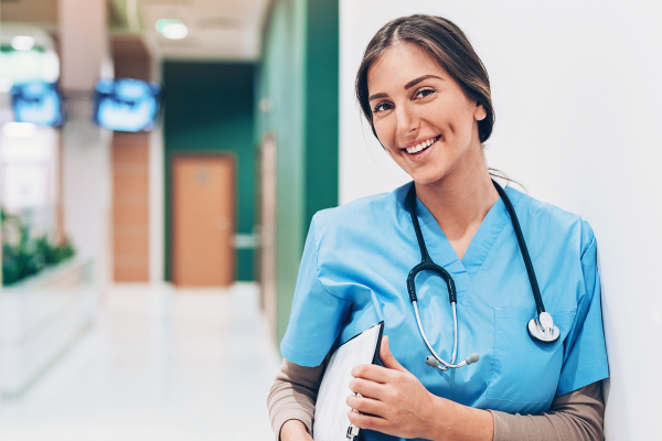 A nurse leaning against a wall