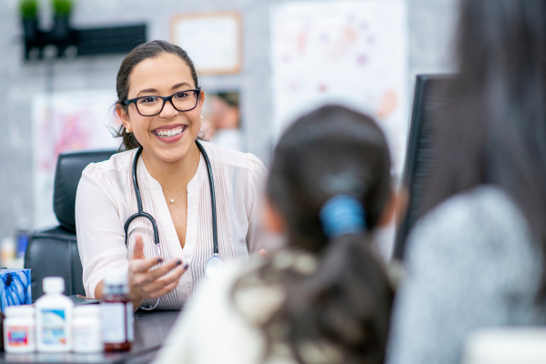 A female medical professional at their desk