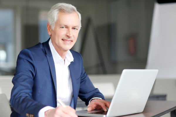 A male professional working at a computer