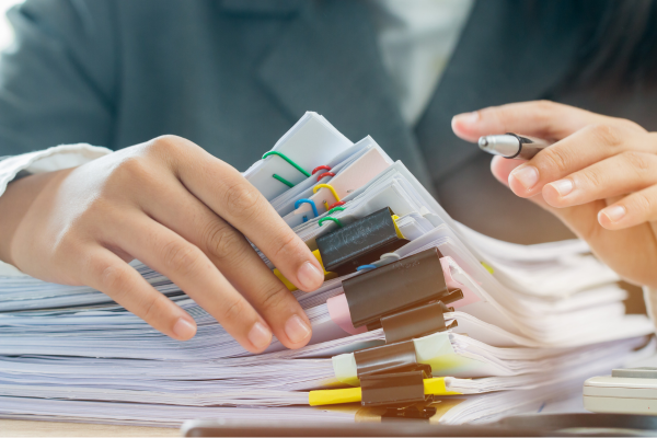 A pile of files on a desk