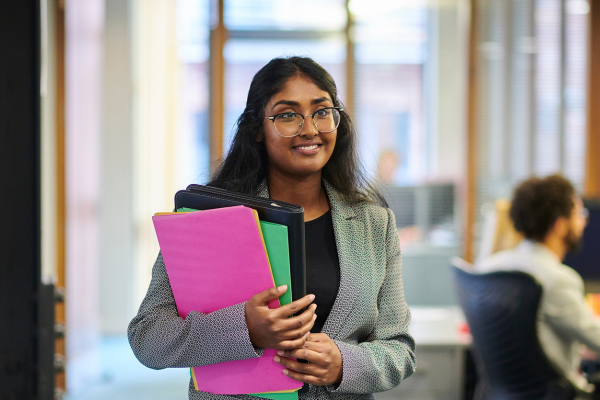 A headteacher stood with school files.