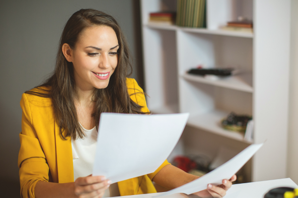 A woman holding a piece of paper