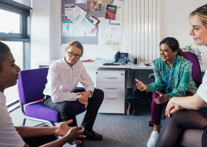 A teacher engaging with classroom students