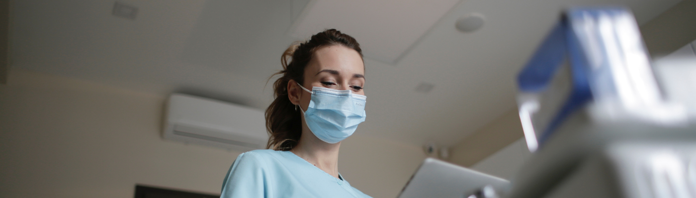 A female nursing professional wearing a face mask