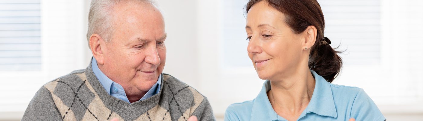 A female professional helping an elderly man