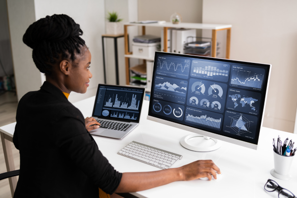 A lady looking at a computer screen displaying data