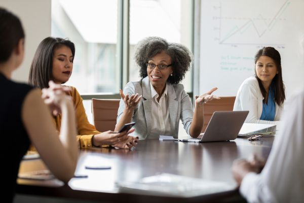 A group of women sat around a table talking