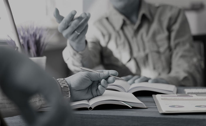 A hand resting on a notebook