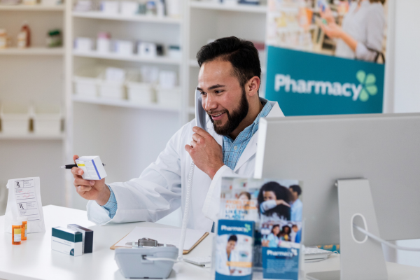 A male Pharmacist on the phone