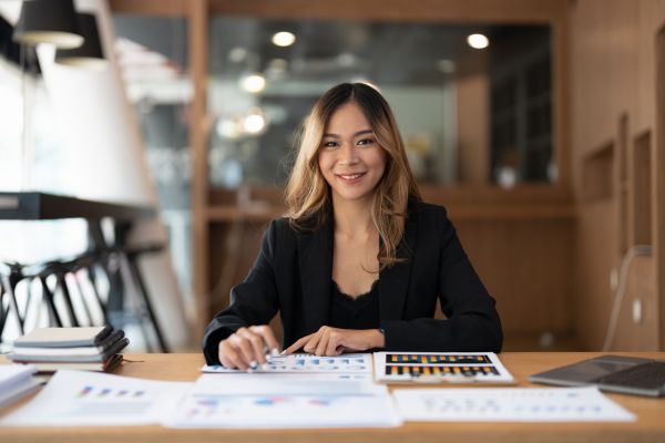 A lady sat at a desk smiling