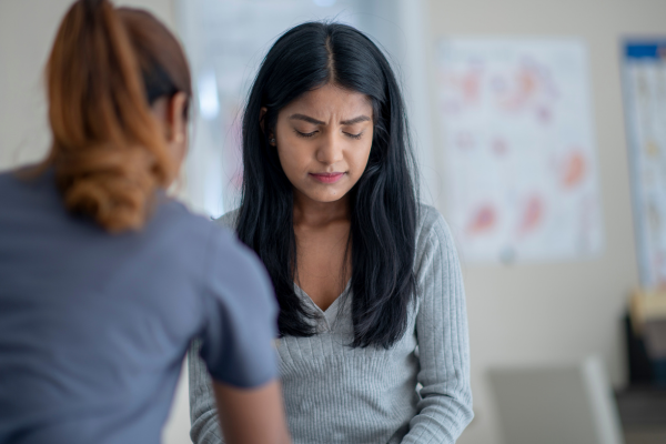 A female Mental Health Nurse sat with a young female