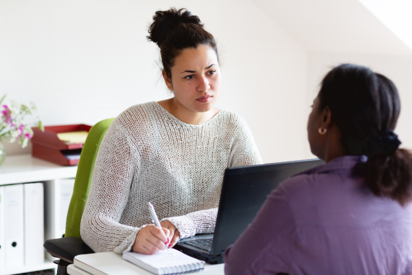 A female Mental Health Support Worker talking to another female