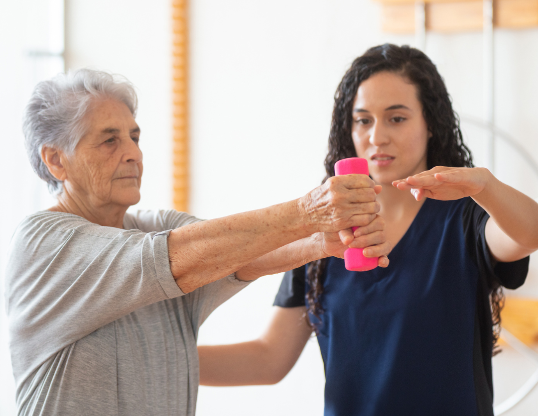 A female Occupational Therapist helping an elderly lady with exercises