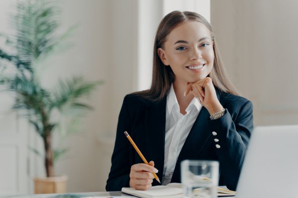 A lady sat at a desk smiling