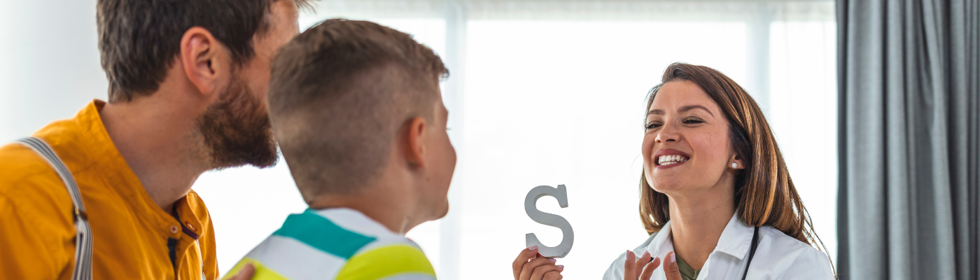 A female professional helping a young boy