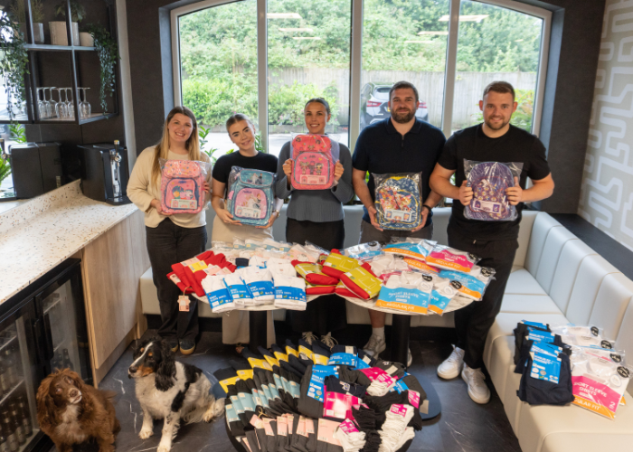 SCG education team with a collection of school uniforms