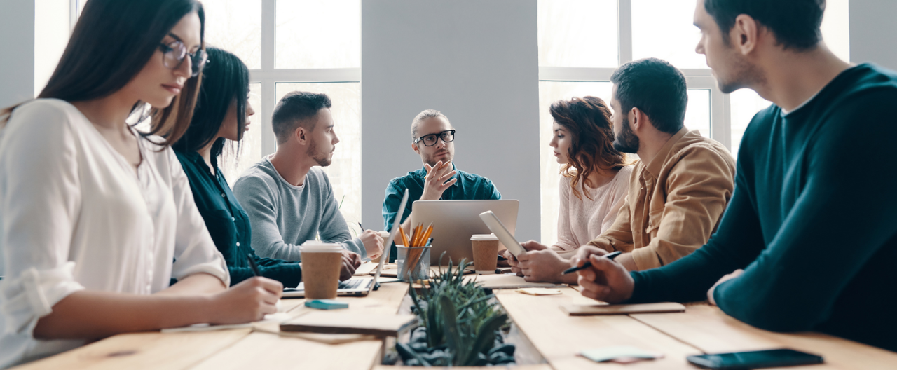 Seven colleagues sat having a discussion