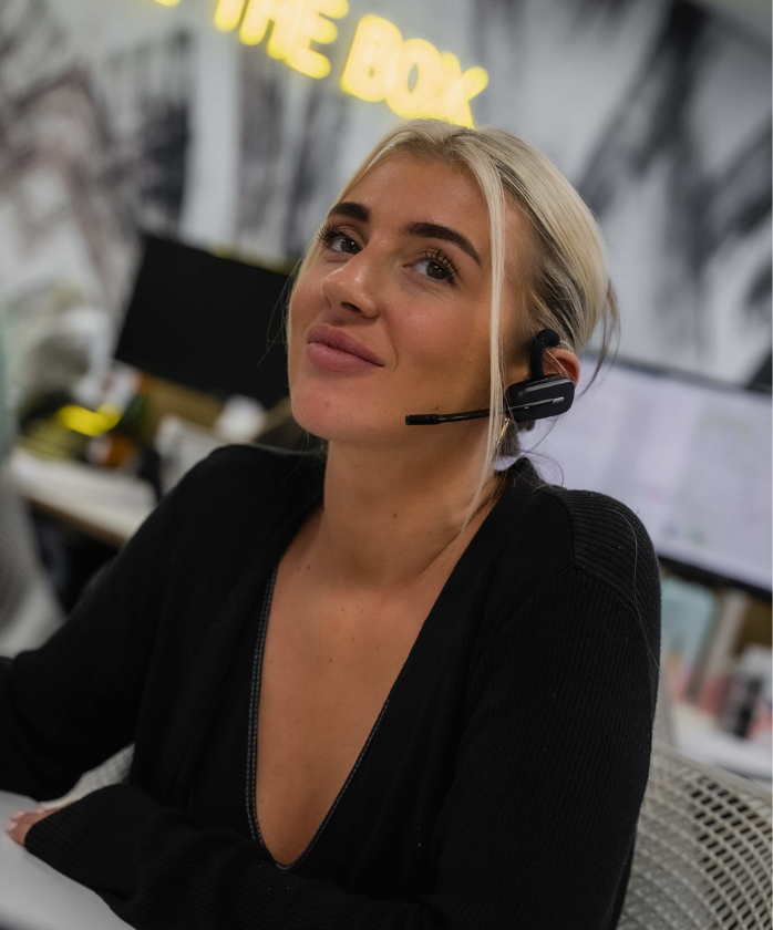 A female Spencer Clarke Group employee sat at desk