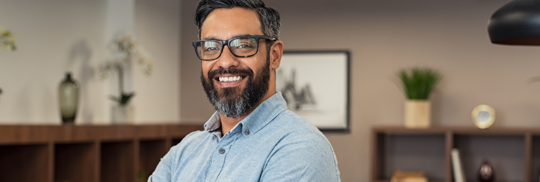 A man wearing glasses smiling