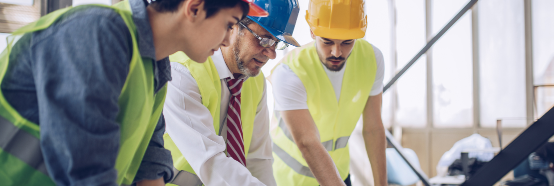 Three construction workers wearing high vis vests