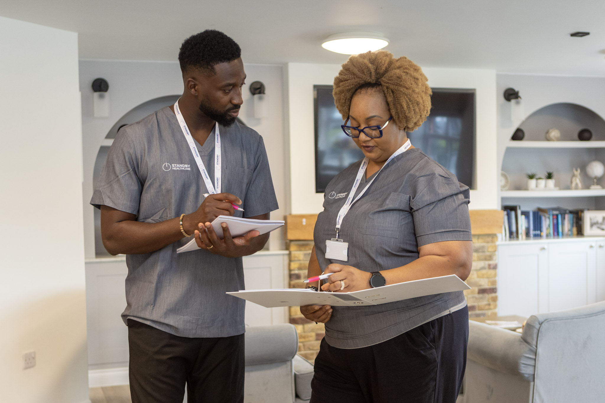 A man and woman talking whilst looking at paperwork