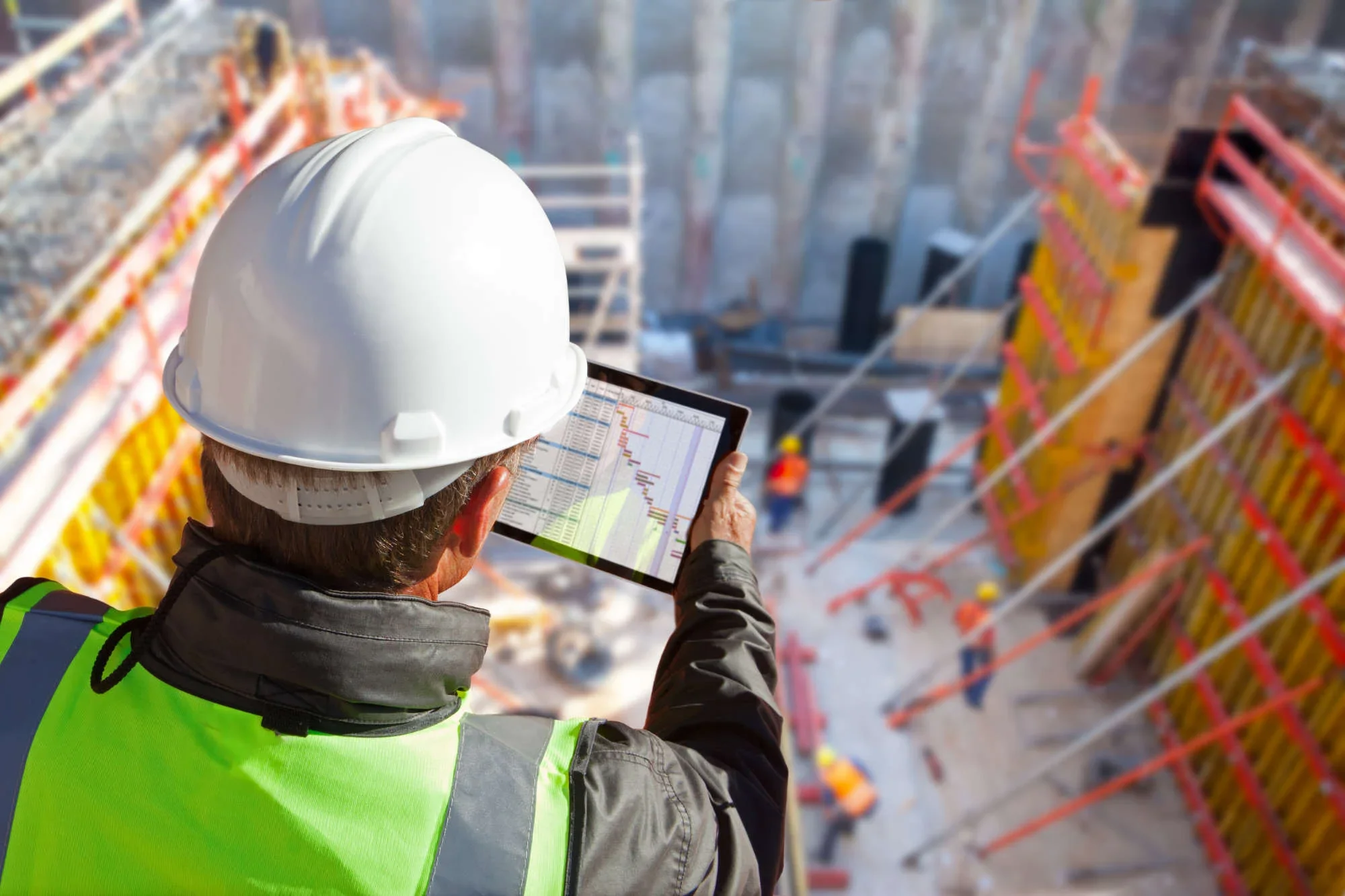 Construction site engineer reading a report