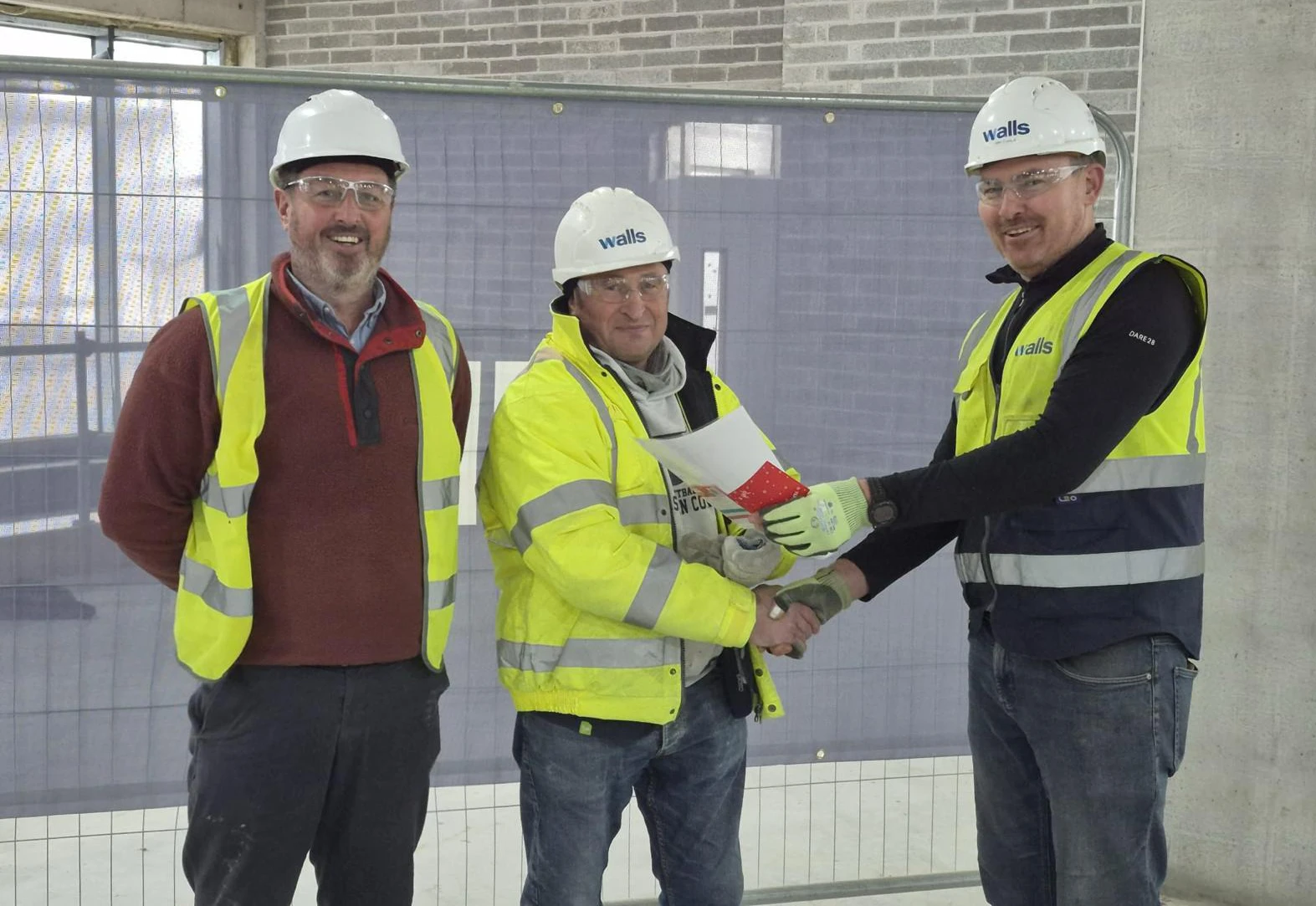 Zinovii receives his award from Darran (left) and John at the site